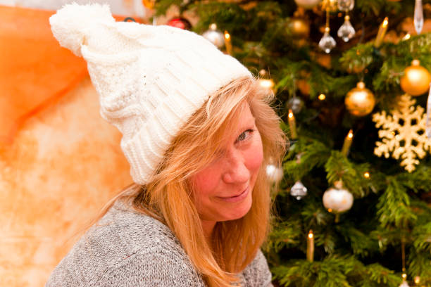 istock Blonde Christmas angel under the Christmas tree looking sensual 1177479490
