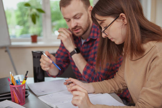 istock Mature mzle teacher working with his teenage students 1177480191