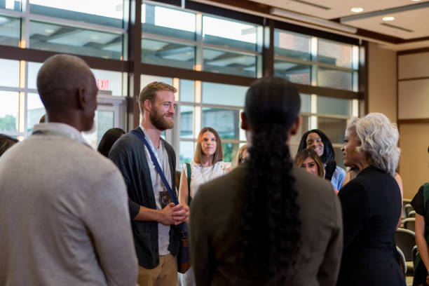 istock Mature conference speaker addresses hipster during Q and A 1177480896