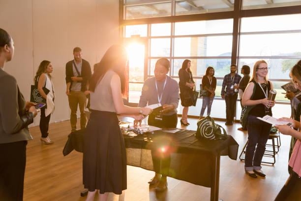 istock Unrecognizable woman gets information at expo registration table 1177480948