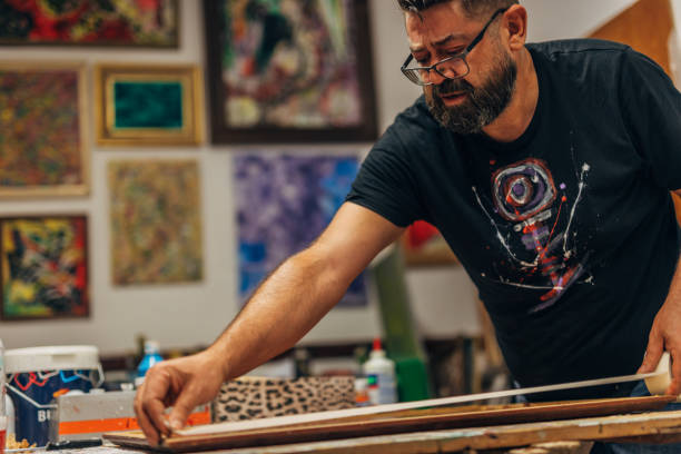 istock Artist using tape to prepare canvas for painting 1177482461