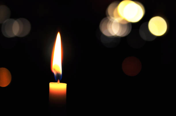 istock Candle light outdoors at night with light balls in the background 1177484251