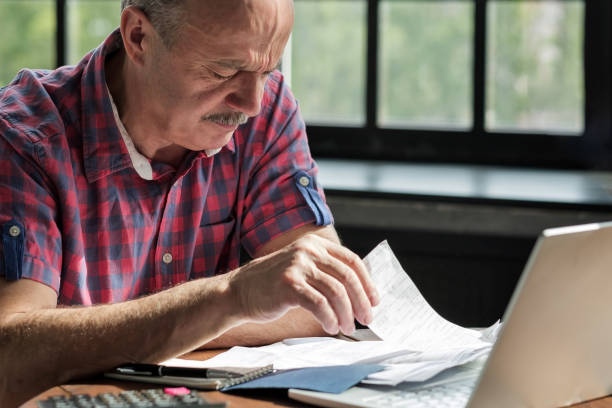 istock Man man checking home finance calculating money. 1177485499