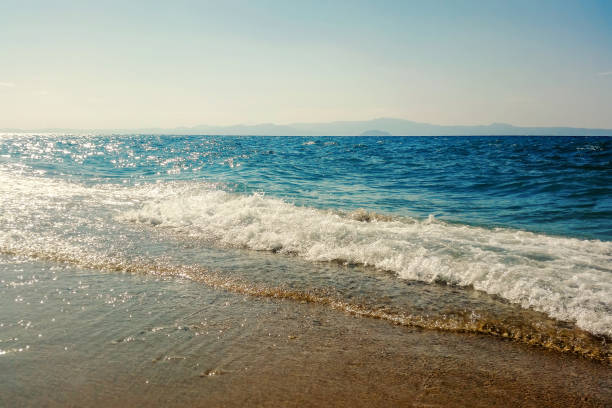 istock Wave of blue ocean on sandy beach Summer Background 1177487320
