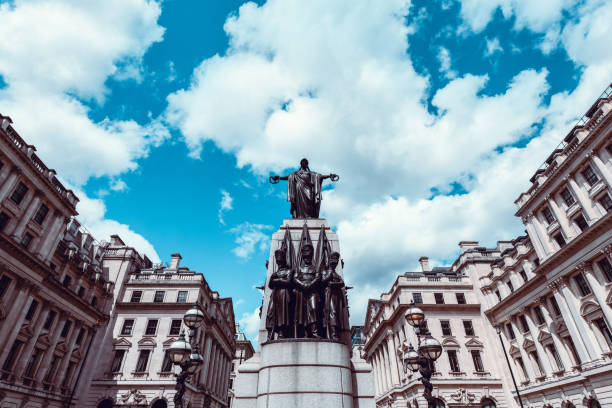 London, UK - November 08 2025: A low angle detail shot of the English Baroque architecture of St Paul's Cathedral's iconic facade and tower against a bright blue sky with light clouds in autumn