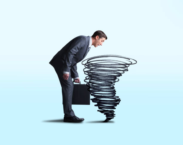 istock Businessman Looking Down Into Swirling Tornado 1177488961