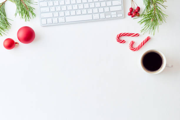 istock Flat lay christmas home office desk with pine branches and keyboard, christmas decorations  on a white background 1177490910