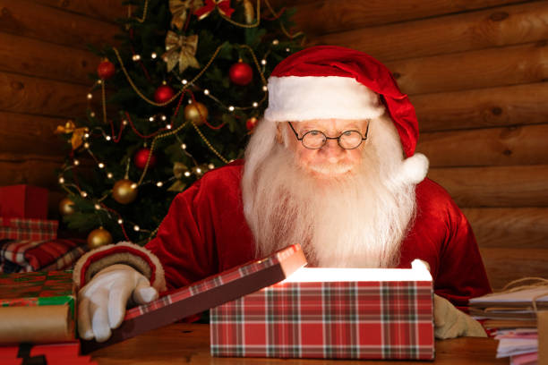 istock Santa Claus looking at light in open giftbox with amazement 1177491660