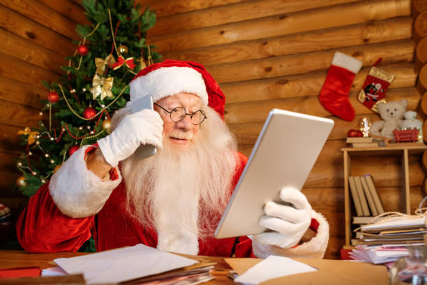 istock Mobile Santa looking through online xmas presents and making order on smartphone 1177491897