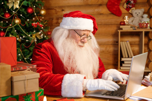 istock Serious Santa concentrating on answering electronic letters by laptop 1177491900