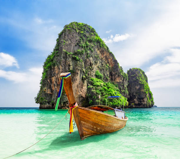 Thai traditional wooden longtail boat and beautiful sand beach. Thai traditional wooden longtail boat and beautiful sand Ao Phra Nang Beach in Krabi province. Ao Nang, Thailand. koh poda stock pictures, royalty-free photos & images