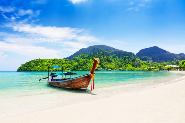 Thai traditional wooden longtail boat and beautiful sand beach. Thai traditional wooden longtail boat and beautiful sand beach at Koh Phi Phi island in Krabi province. Ao Nang, Thailand. ko samui stock pictures, royalty-free photos & images