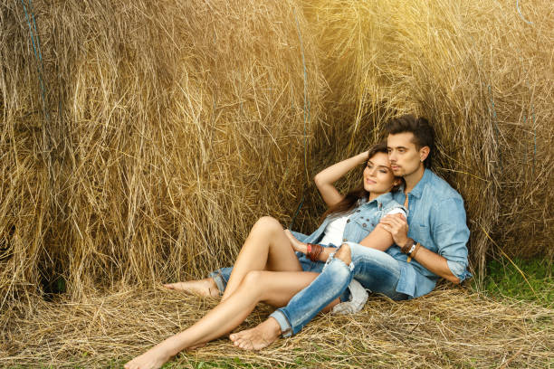 istock Young lovely couple is relaxing among the haystacks 1177494201