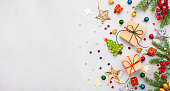 Christmas background with gift boxes, festive decor, fir tree branches.