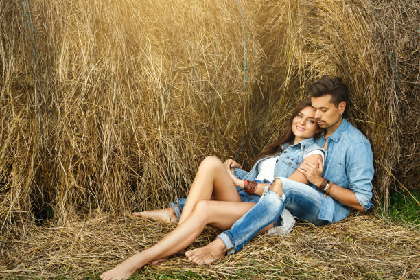 istock Young lovely couple is relaxing among the haystacks 1177495002