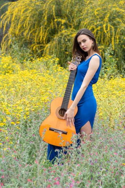 istock Attractive young beautiful woman holding a classic guitar. 1177496790