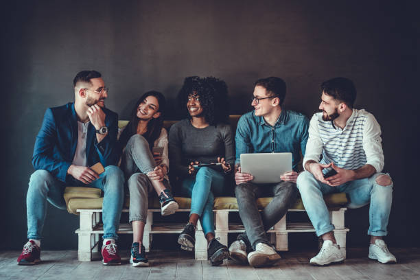 istock Multiethnic university students studying together. Young people working with tests and gadgets, sitting on the couch. 1177497718