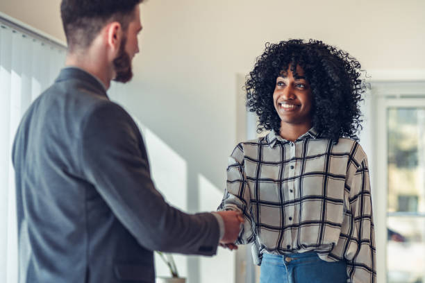 businesswoman making handshake with a businessman. Business people shaking hands - businesswoman making handshake with a businessman. gripping stock pictures, royalty-free photos & images