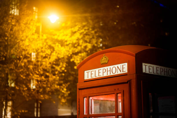 Classic British red colored pay telephone booth in London, England, UK. Horizontal shot.