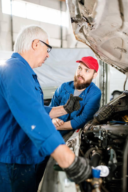 istock Experienced worker explaining his young colleague how to maintain vehicles 1177501638