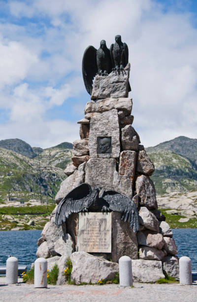 St Gotthard Mountain Pass in the Swiss Alps Gotthard pass, Canton Ticino, Switzerland, 7/31/2014: It's in the photo Memorial for the downed pilot Adrien Guex on the Gotthard pass; Ticino, Switzerland. First lieutenant Adrien Guex crashed and was killed on 7 August 1927in his Fokker D VII, 627 during a reconnaissance flight due to poor visibility. The monument made by Fausto Agnelli was inaugurated on 18 August 1928. gotthard pass stock pictures, royalty-free photos & images