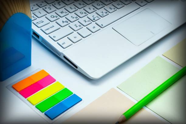 istock notebook, pen, computer keyboard and colored pieces of paper on a white background 1177502997