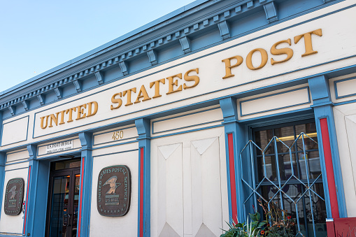 Park City, USA - July 25, 2019: Utah city street in historic town with closeup of exterior building post office USPS sign entrance