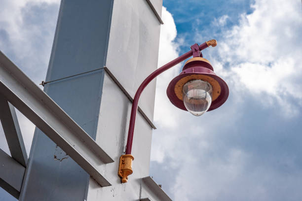 istock Lantern hanging on a metal pole against a blue sky 1177504942
