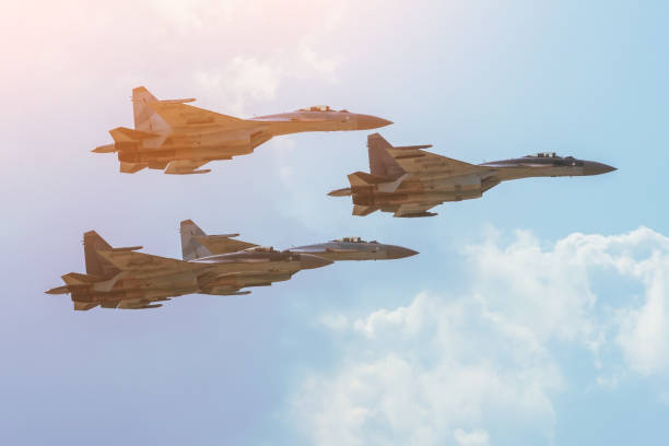 istock Group of four aircraft fighter jet airplane sun glow toned gradient sky. 1177505548