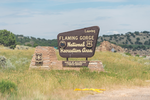 Manila, USA - July 24, 2019: Sign for leaving Flaming Gorge Utah National Recreational Area Park near Wyoming border side