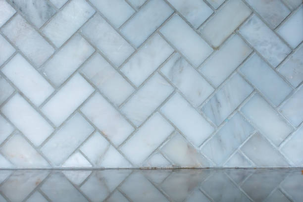 istock white and gray herringbone italian marble tile in a kitchen as a backsplash with the reflection on the granite countertop 1177513126