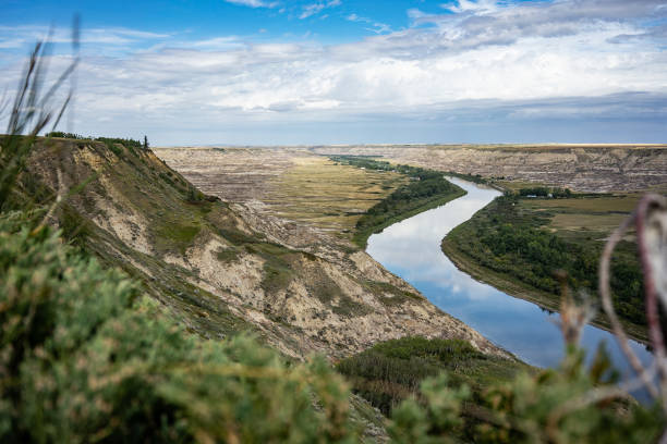 istock Reflective river cutting through sedimentary rock canyon and shrubs 1177514623