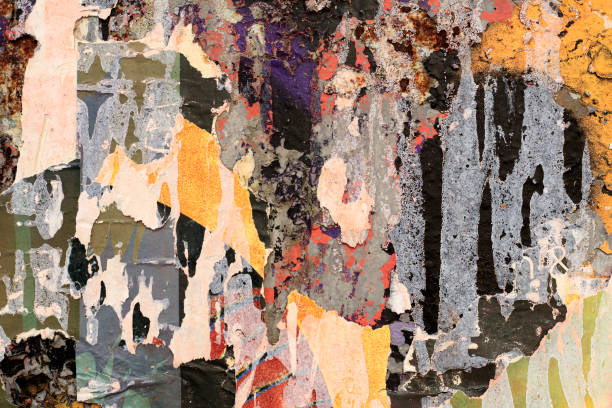 Pieces of torn paper peeling off wall used as billboard Torn Ripped Paper Poster Street Wall Surface. Grunge Rough Dirty Rust Background postmark photos stock pictures, royalty-free photos & images