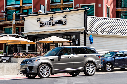 Park City, USA - July 25, 2019: Ski resort famous town street in Utah during summer with restaurant coal and lumber sign in downtown building