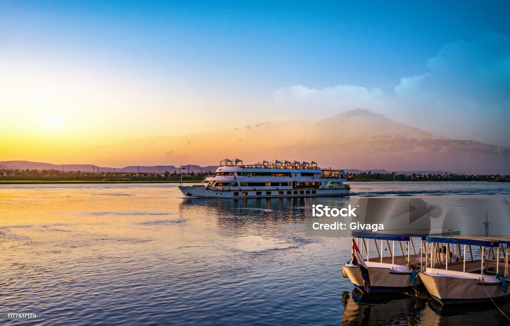 River Nile and ship River Nile and ship at sunset in Aswan Nile River Stock Photo
