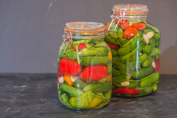 istock Preserves or pickled vegetables in glass jars. 1177517586