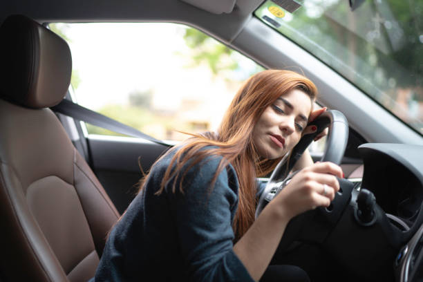 istock Exhausted woman sleeping in steering wheel 1177517761