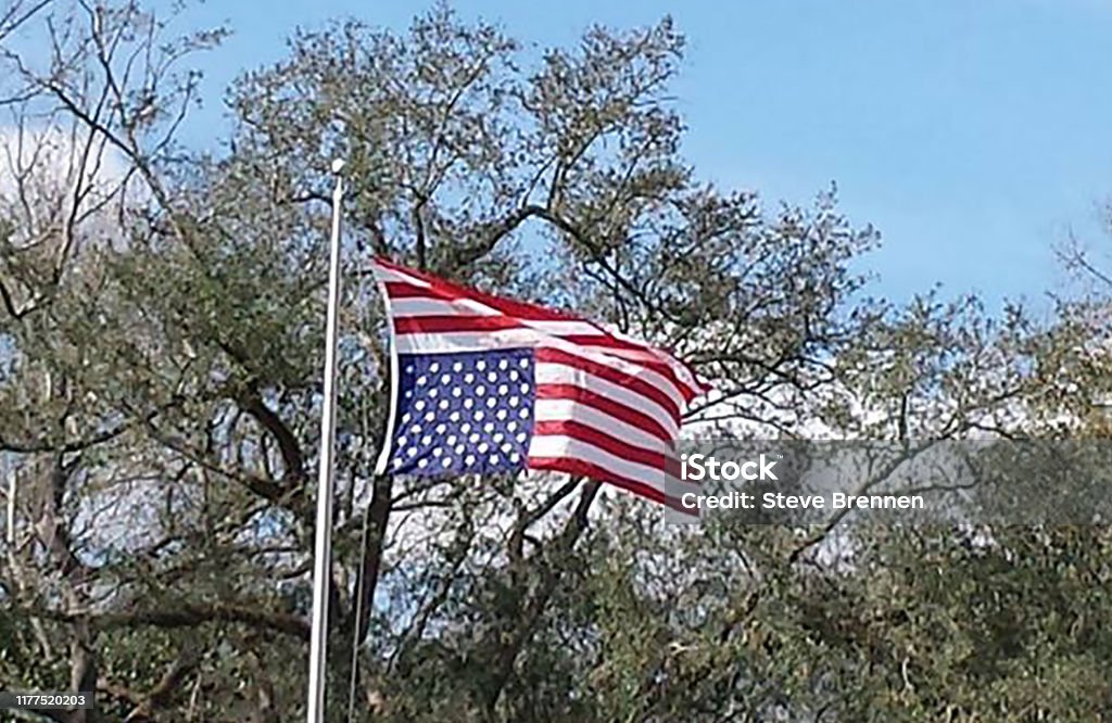 USA Flying Flag Upside Down USA Flying Flag Upside Down blowing in the wind Upside Down Stock Photo