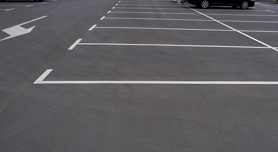 Empty parking with clear markings and arrows indicating the direction of movement. Modern car parking. Marking on asphalt road.