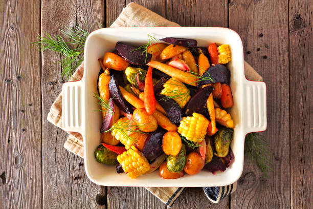 istock Roasted autumn vegetables in a baking dish, top view over rustic wood 1177528430