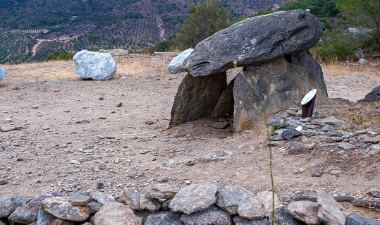Antique dolmen in the mountains on the mediterranean coast. Dolmen built of three large stones near tourist routes in the mountains.