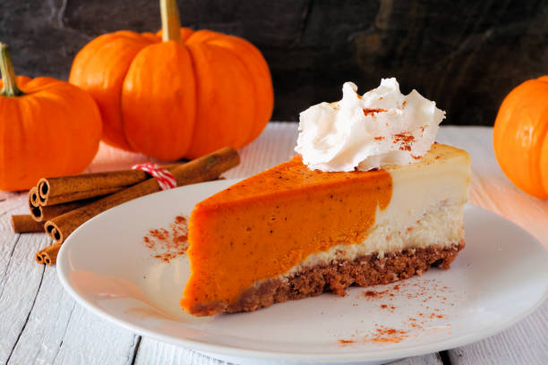 istock Slice of pumpkin cheesecake with whipped cream, side view table scene 1177529917