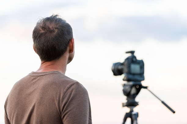 man standing looking at view closeup with camera on tripod at canyon rim overlook view near campground in flaming gorge utah national park - 16019 imagens e fotografias de stock