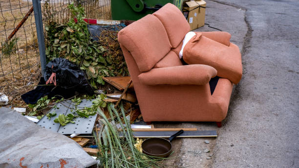 istock Old sofa stands near the garbage cans on Garbage dump in europe. 1177530399