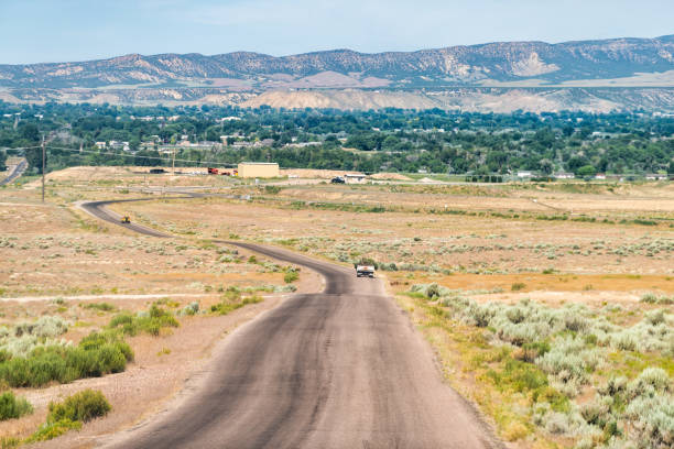 Jensen or Vernal Utah road highway with view of city near Dinosaur National Monument desert landscape Jensen or Vernal Utah road highway with view of city near Dinosaur National Monument desert landscape vernal utah stock pictures, royalty-free photos & images