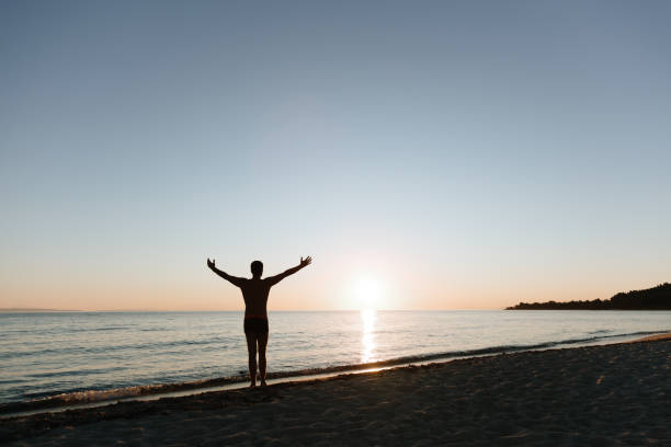 istock Young man looking at sunset by the sea 1177532075