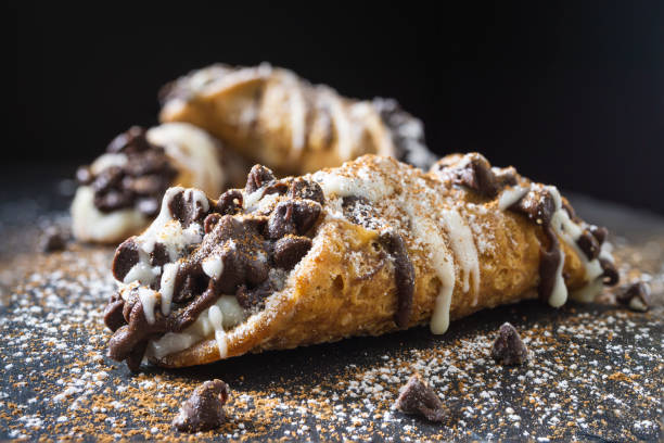 Italian cannoli pastry Close up of pastries on dark background cannoli photos stock pictures, royalty-free photos & images