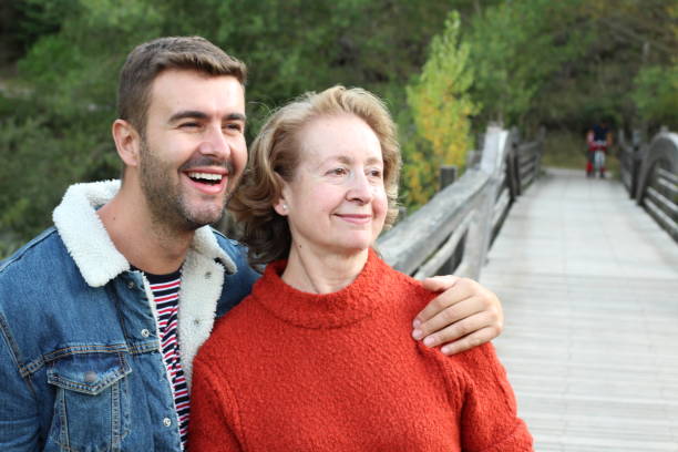 Mother and son smiling outdoors Mother and son smiling outdoors. age contrast stock pictures, royalty-free photos & images