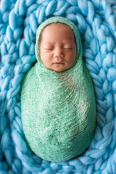 istock baby sleep on a green wrap cloth feelgood relaxing 1177534503