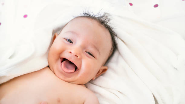 istock baby relieved after bath. smiling baby after bath 1177540075